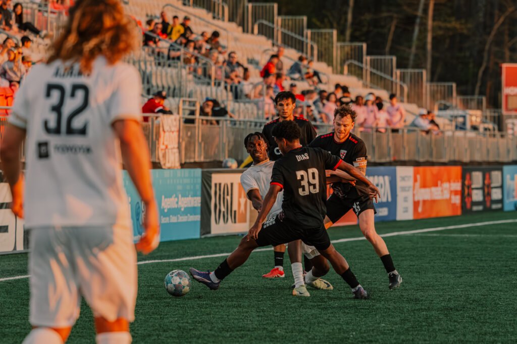 Louisville City FC Tola Showunmi (14) being pressed by 3 Loudoun United FC players when trying to complete a pass in order to rotate the play at a USL Championship game vs Loudoun United FC at Segra Field in Loudoun, Virginia on April 10th, 2026 - Photo Credit - Omar Yair Soto with LAMomentum