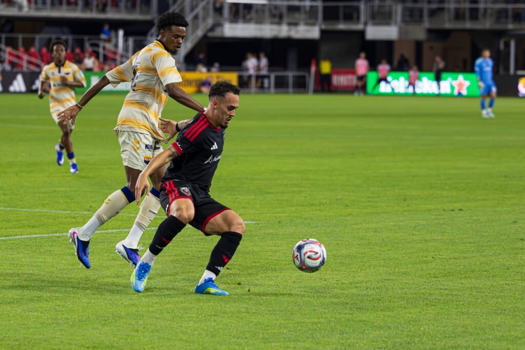 DC United's João Peglow shielding the ball from One Knoxville SC's defender after a close corner kick in the Lamar US OPEN Cup at Audi Field in Washington DC on April 15th, 2026 - Photo Credits - Omar Yair Soto with LAMomentum