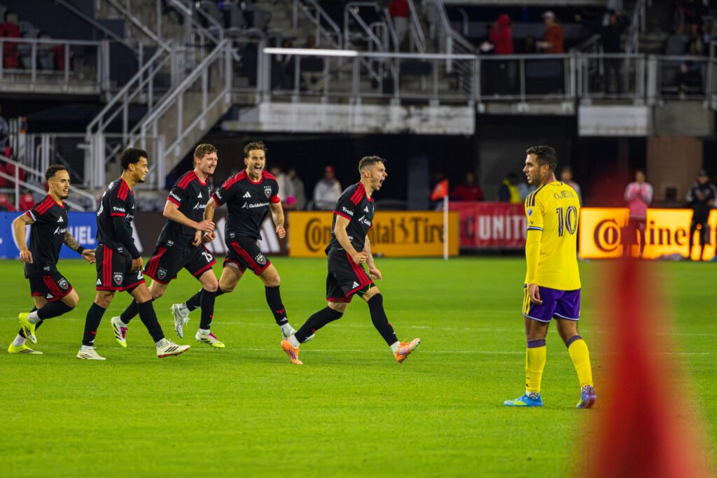DC United's Louis Munteanu celebrating his goal with team to tie the game for DC United against Orlando City at Audi Field in Washington DC on April 25th 2026. - Photo Credits - Omar Yair Soto