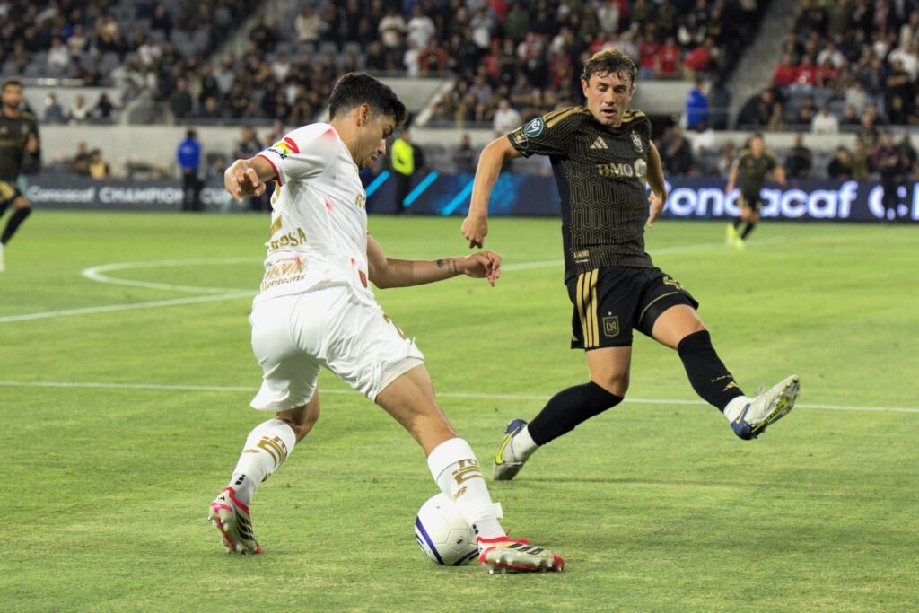 Diego Zaragoza controls the ball under pressure from Kenny Nielsen during the Concacaf Champions Cup semifinal between Deportivo Toluca FC and Los Angeles FC at BMO Stadium in Los Angeles, California on April 29, 2026. Joao Portugal