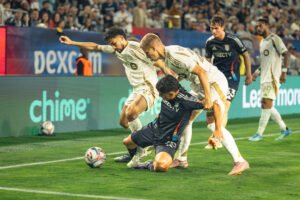 San Diego FC's Alejandro Alvarado (70) is brought down under heavy pressure by LAFC's Mathieu Choiniere (66) and Artem Smoliakov (29) as they battle for possession near the sideline in the second half on May 2, 2026 at Snapdragon Stadium in San Diego, CA. - Adrian Perez for LAMomentum