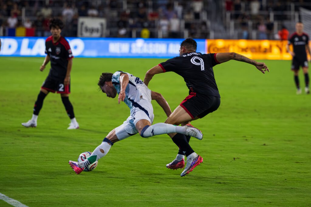 MLS - New England Revolutions' defender #23 William Sands fighting to stay balanced against DC United's Tai Baribo #9 during a play at a MLS game at Audi Field on August 19th 2026. Photo Credits - Omar Yair Soto