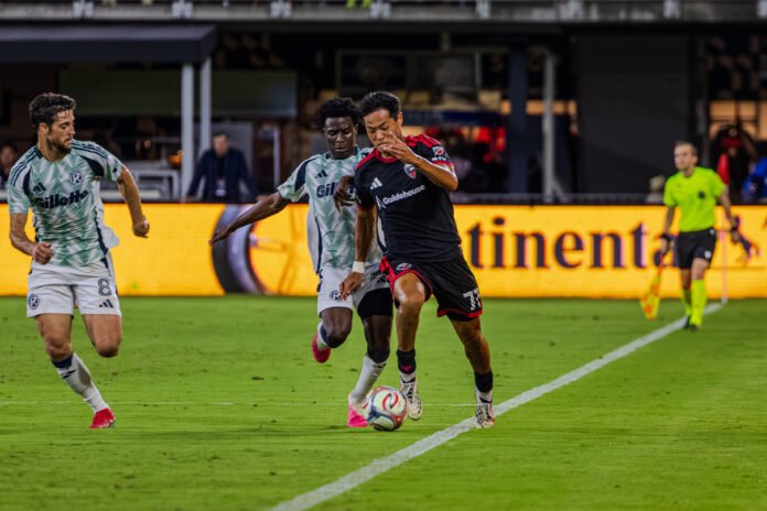 MLS - DC United's Hosei Kijima #77 getting through defender of New England Revolution down the line into a attacking opportunity at a MLS game in Audi Field on August 19th 2026. Photo Credits - Omar Yair Soto
