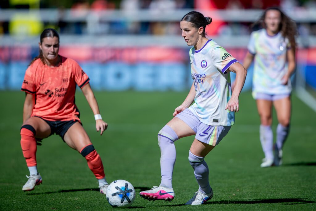 Orlando Pride midfielder Haley McCutcheon controls the ball under pressure from a Bay FC player at PayPal Park.