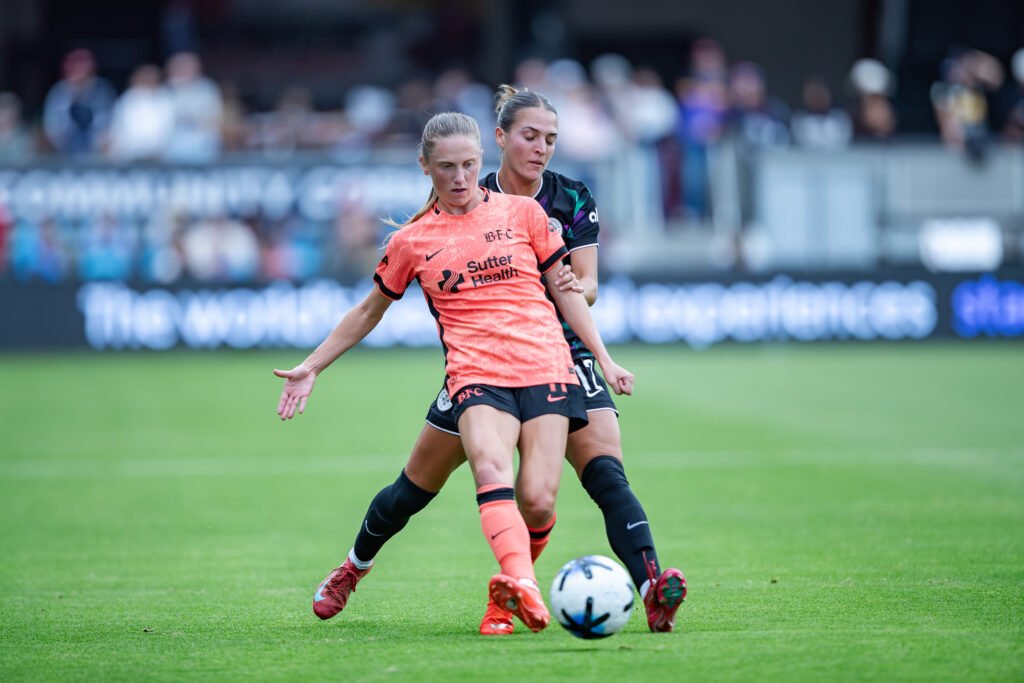 Hannah Bebar of Bay FC wins possession against Quincy McMahon of Racing Louisville FC at PayPal Park.