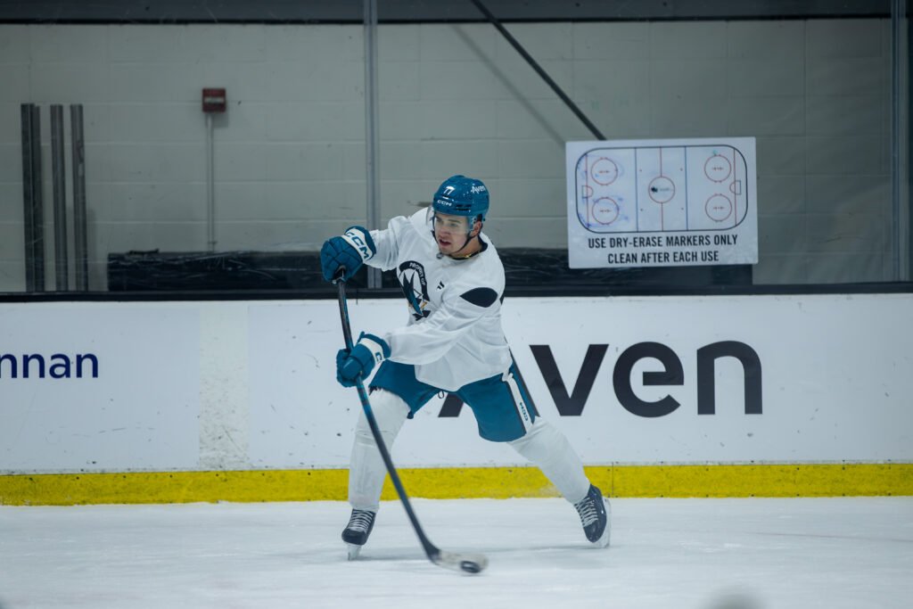 Michael Misa #77 shoots the puck during San Jose Sharks training camp