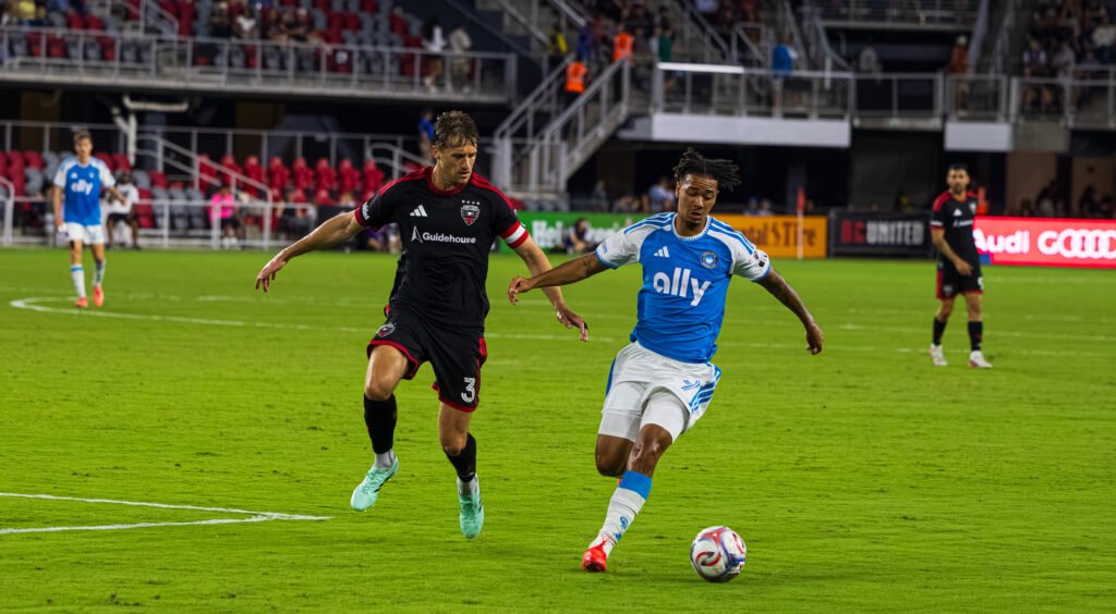 MLS - DC United's defender Lucas Bartlett dropping down the line to pressure Charlotte FC's striker Idan Toklomati #9 in a MLS game at Audi Field in Washington DC on September 19th, 2026. Photo Credits - Omar Yair Soto