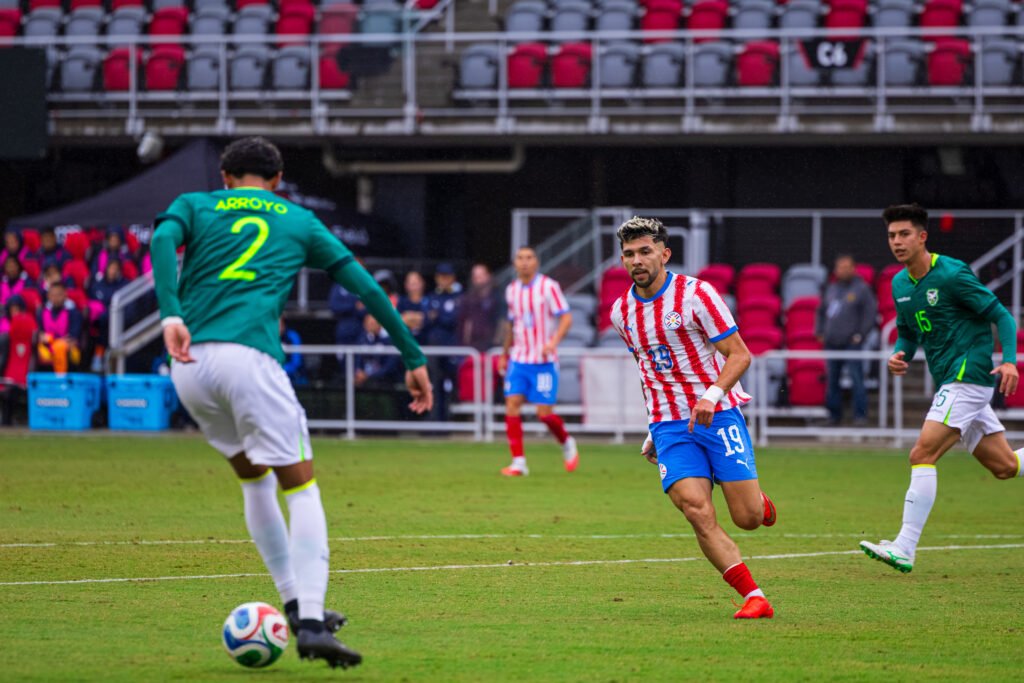 Paraguay's #19 Julio Encisio pressuring Bolivia defender #2 Diego Arroyo at Audi Field in Washington DC on Sunday September 27th 2026. Photo Credits - Omar Yair Soto