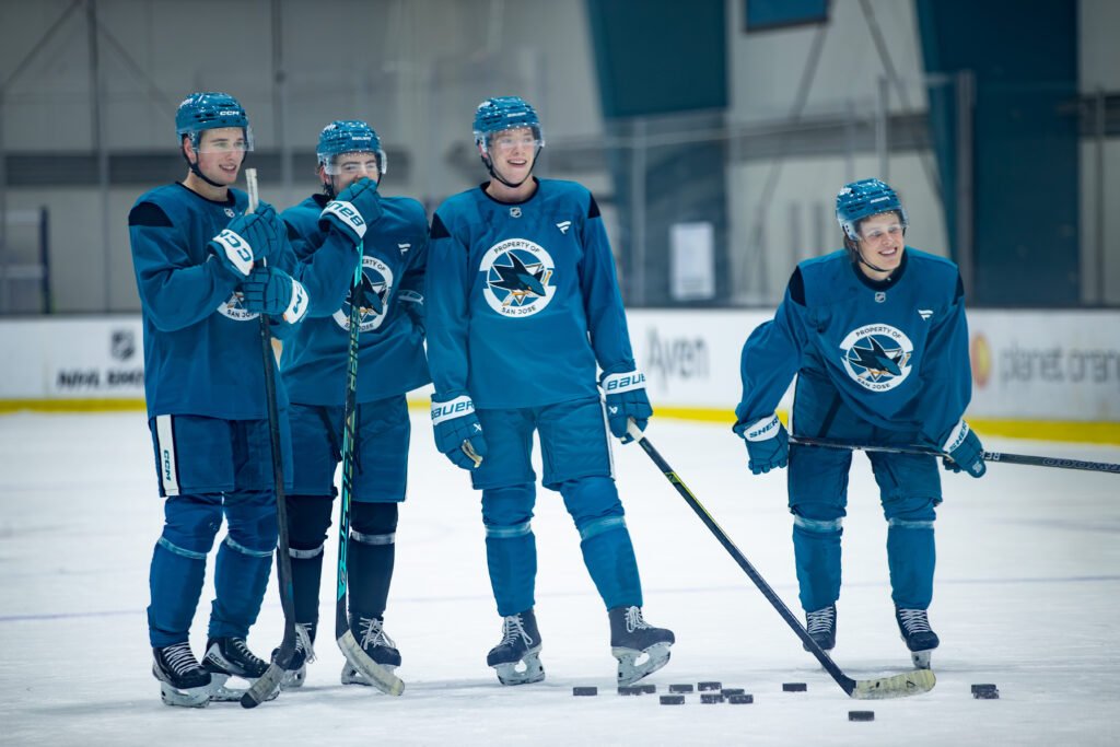 Macklin Celebrini, Luca Cagnoni, Ivar Stenberg and Collin Graf share a lighthearted moment after San Jose Sharks practice.