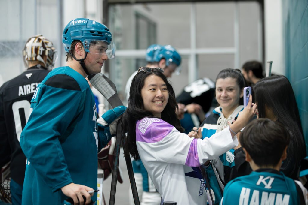 Macklin Celebrini takes a selfie with a fan during San Jose Sharks Training Camp at Sharks Ice in San Jose.