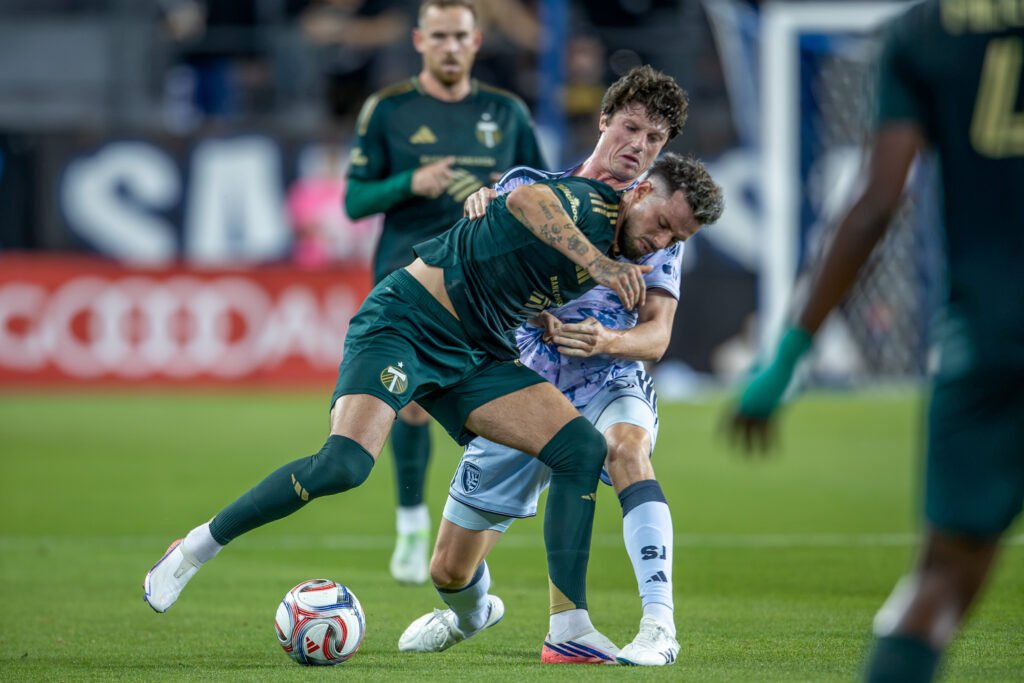 Kristoffer Velde of the Portland Timbers battles Daniel Munie of the San Jose Earthquakes for possession.