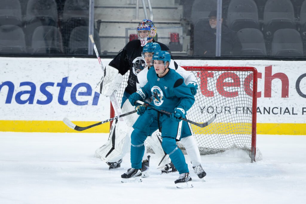 Macklin Celebrini skates in front of San Jose Sharks teammates during training camp at Sharks Ice in San Jose.