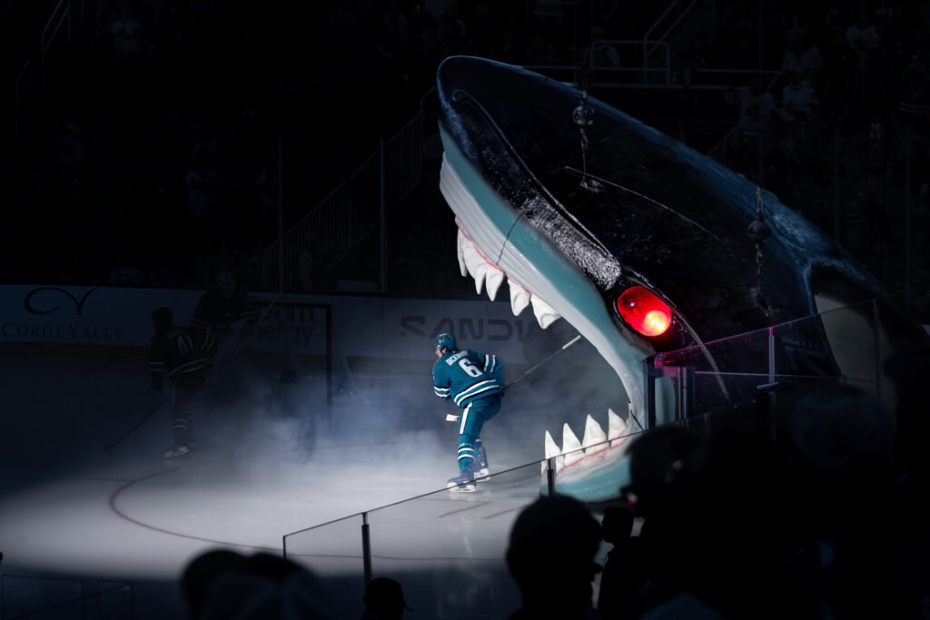 A San Jose Sharks player skates onto the ice through the team's iconic giant shark head entrance before an NHL game against the Buffalo Sabres at SAP Center on October 27, 2026.