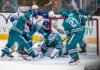 San Jose Sharks goaltender Yaroslav Askarov (#30) protects the net under heavy pressure from Buffalo Sabres players during an NHL game at SAP Center on October 27, 2026.