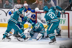 San Jose Sharks goaltender Yaroslav Askarov (#30) protects the net under heavy pressure from Buffalo Sabres players during an NHL game at SAP Center on October 27, 2026.