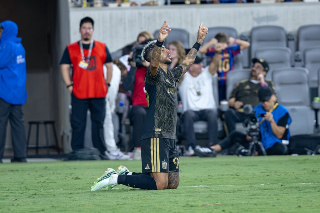 Denis Bouanga (99) drops to his knees and points to the sky in celebration after scoring his 2nd goal of the night for LAFC on Wednesday night at BMO Stadium in Los Angeles, CA - photo by Adrian Perez
