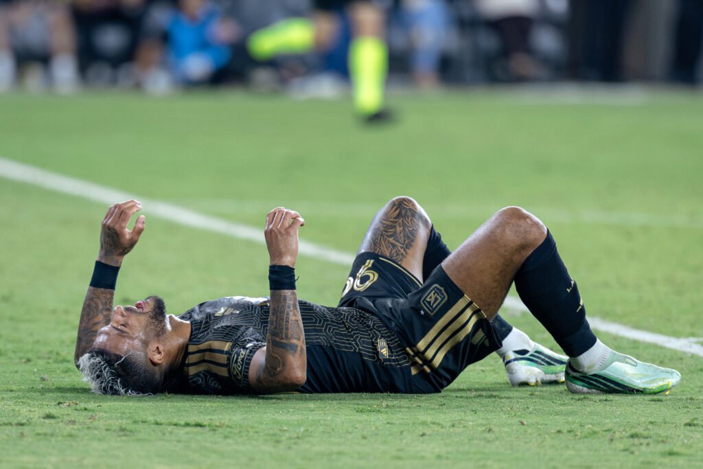 Exhaustion sets in for Denis Bouanga (99) as he lies on the pitch following the final whistle, having played the full 90 minutes and scoring 2 goals for LAFC on Wednesday night at BMO Stadium in Los Angeles, CA - photo by Adrian Perez