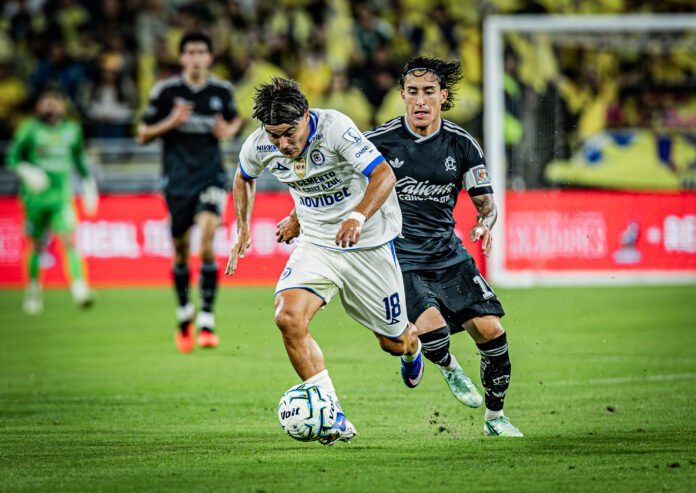 Cruz Azul's Luka Romero (18) beats América's Alejandro Zendejas (10) to create an attacking opportunity in a friendly game on Thursday night at Snapdragon Stadium in San Diego, CA - photo by Adrian Perez