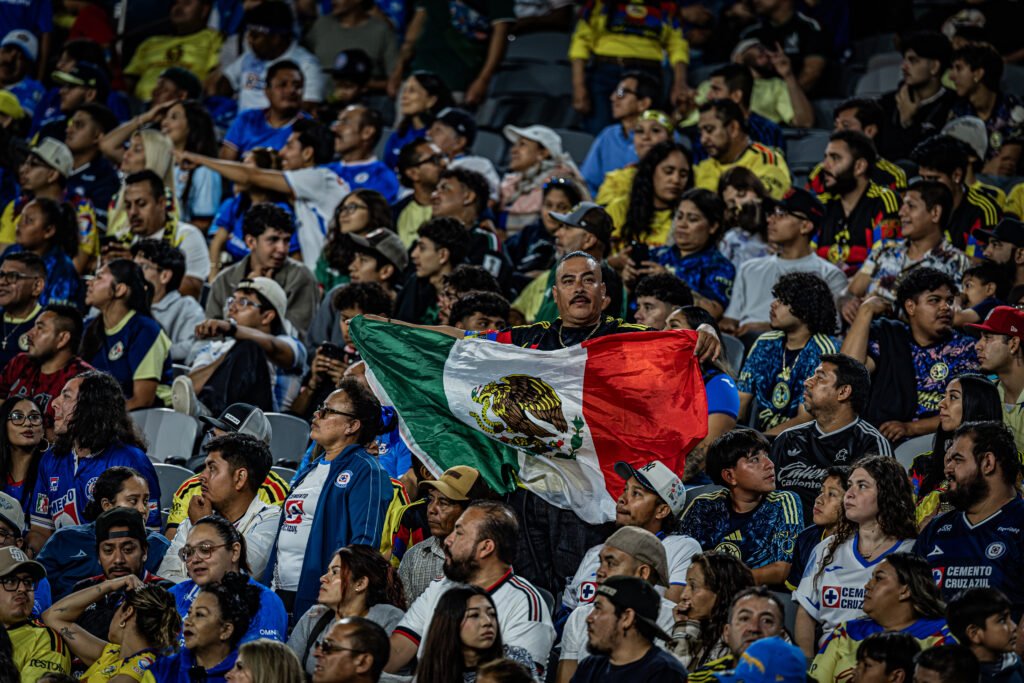 A Supporter in the stands holds up the Mexican flag with pride during el Clásico Joven between América and Cruz Azul in a friendly game on Thursday night at Snapdragon Stadium in San Diego, CA - photo by Adrian Perez