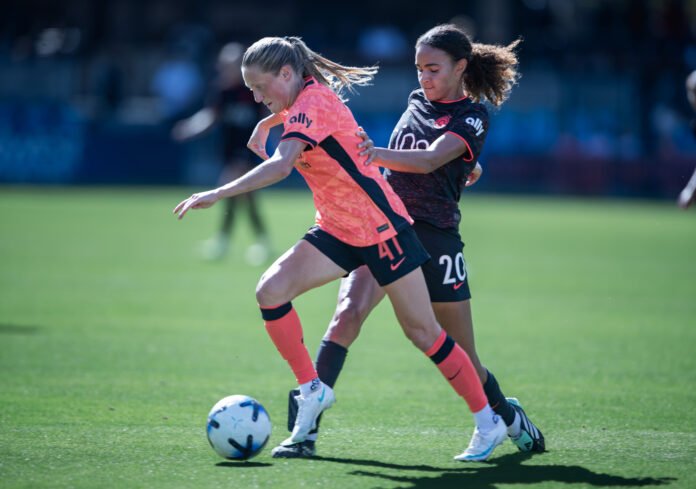 Bay FC's Hannah Bebar challenges Portland Thorns midfielder Nina Nijstad for the ball during an NWSL match.