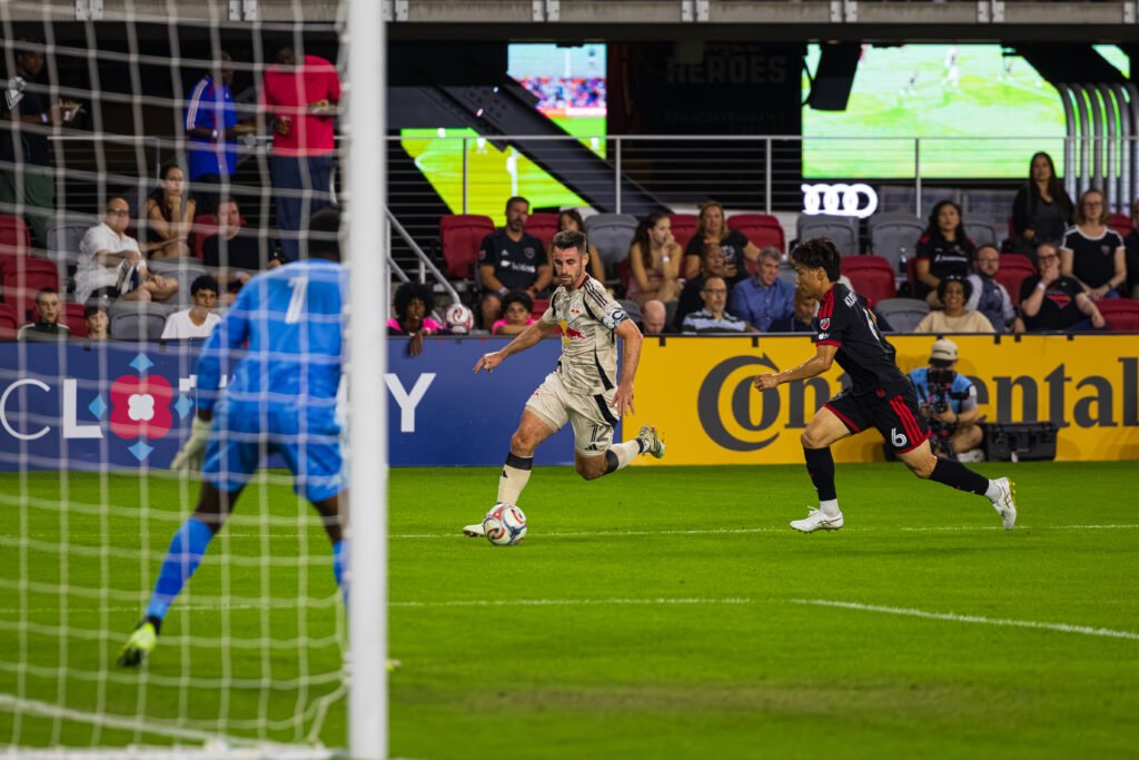 MLS - Red Bull's Dylan Nealis #12 running down the line passing DC United's Keisuke Kurokawa at a MLS game at Audi Field in Washington DC on October 14th, 2026. Photo Credits - Omar Yair Soto