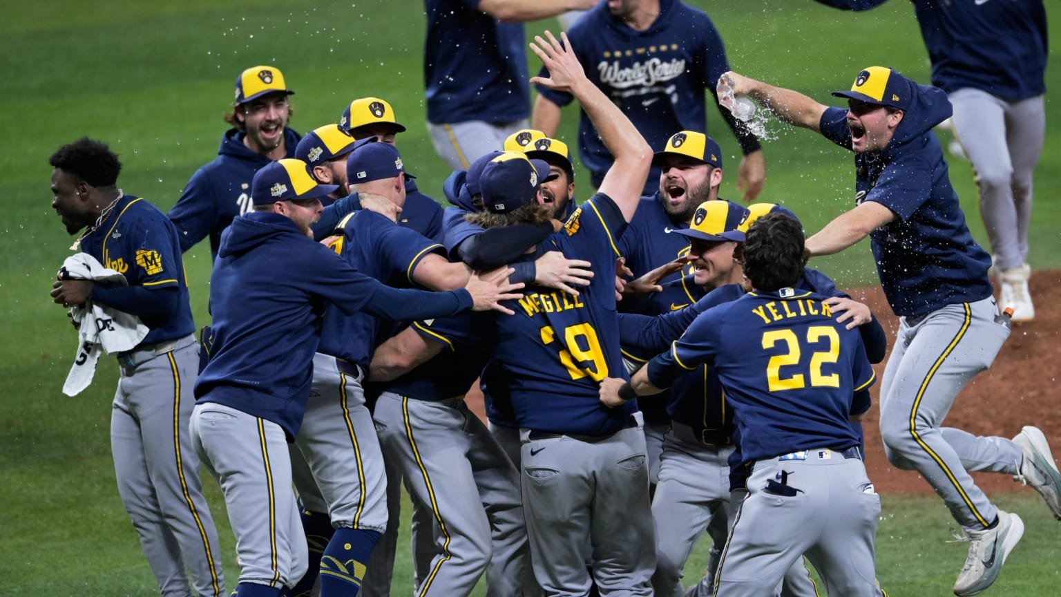 Brewers players celebrate on the field after the final out of Game 5