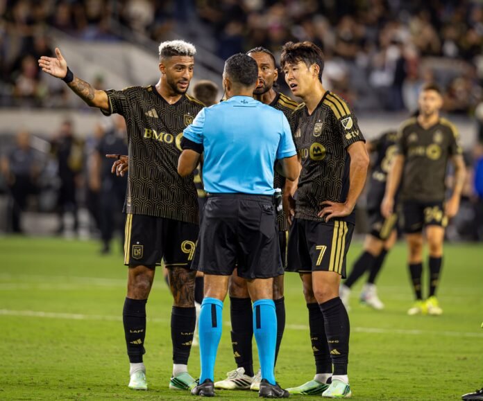 Son Heung-min and Denis Bouanga speaking with the referee during LAFC vs Vancouver at BMO Stadium.