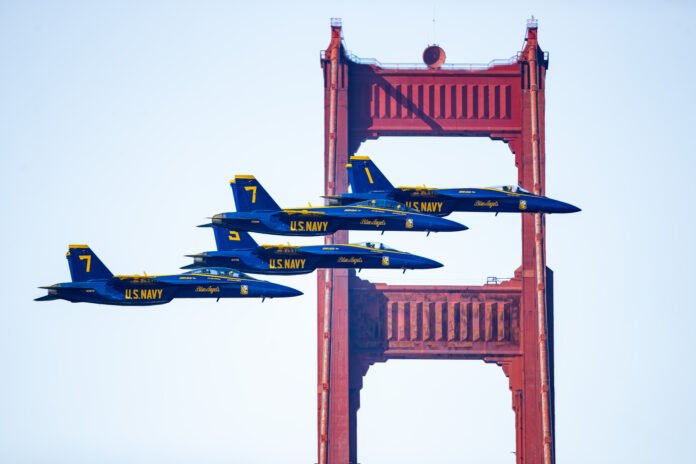 Blue Angels squadron flying in formation past the Golden Gate Bridge during San Francisco Fleet Week.