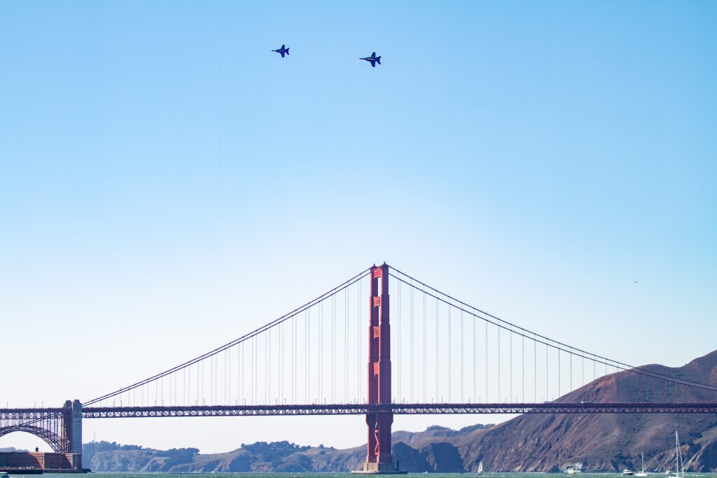 Two Blue Angels jets fly over the Golden Gate Bridge during Fleet Week in San Francisco.