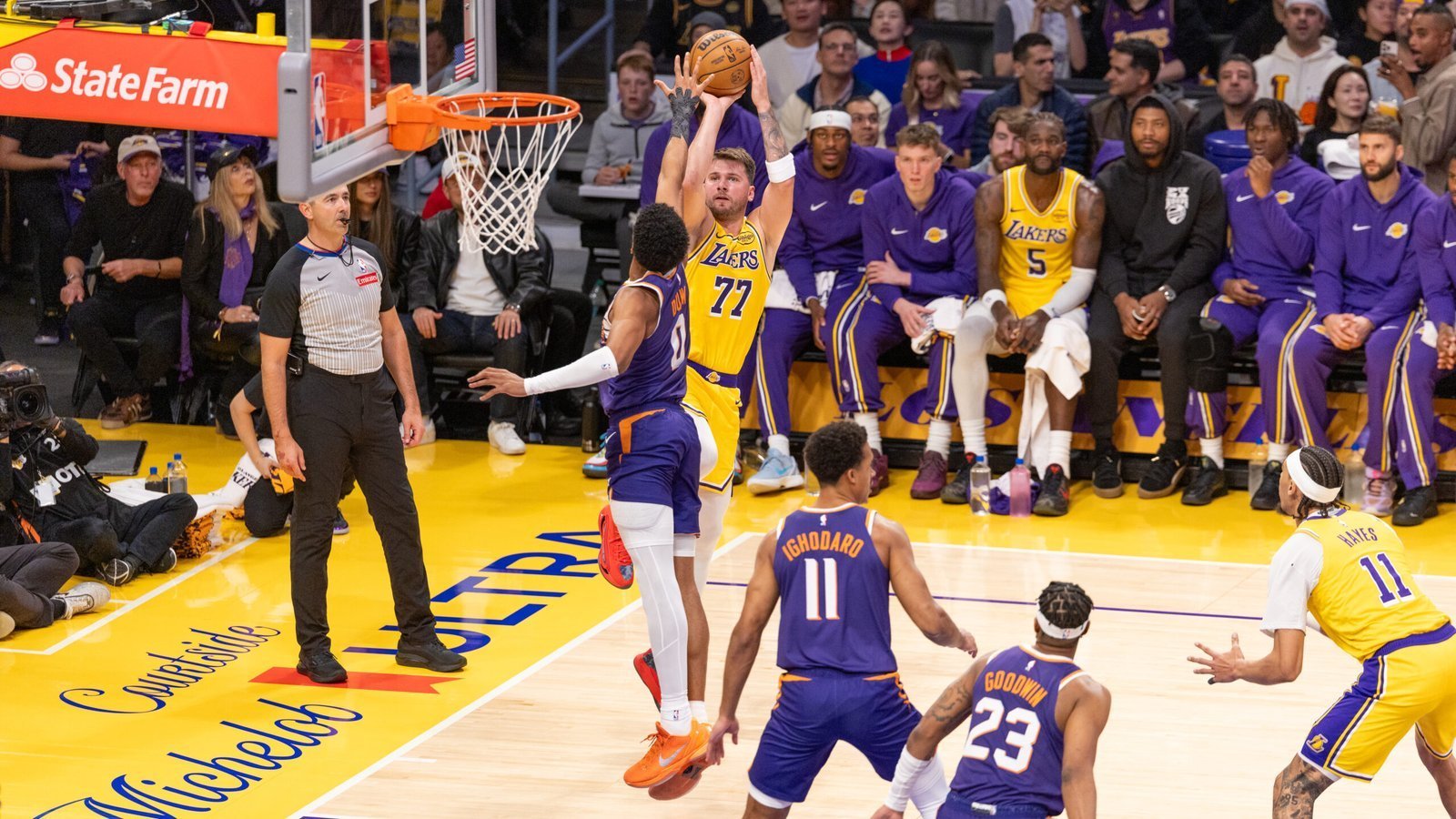 Lakers star Luka Dončić shooting over a defender