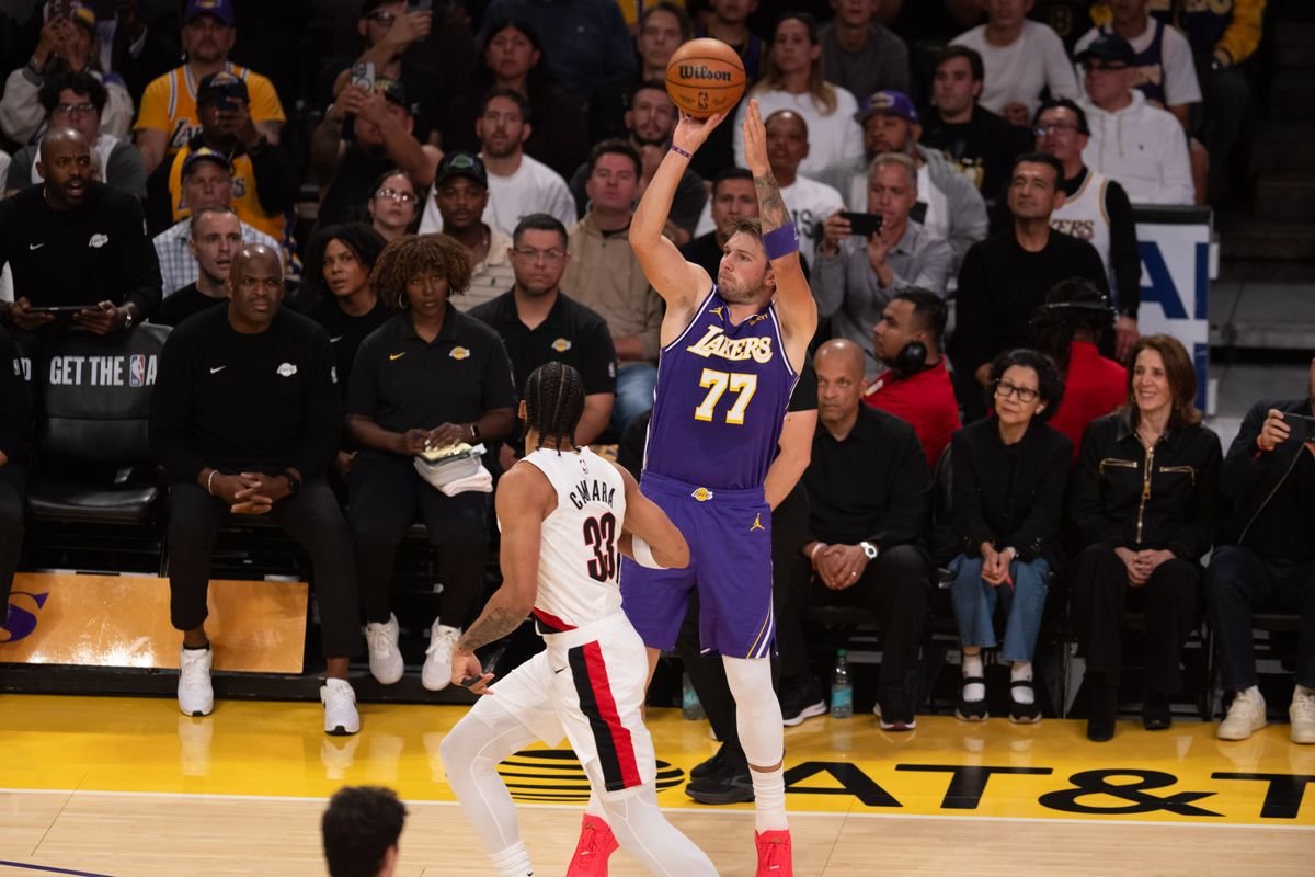 Luka Doncic shoots a three-pointer against the Portland Trail Blazers