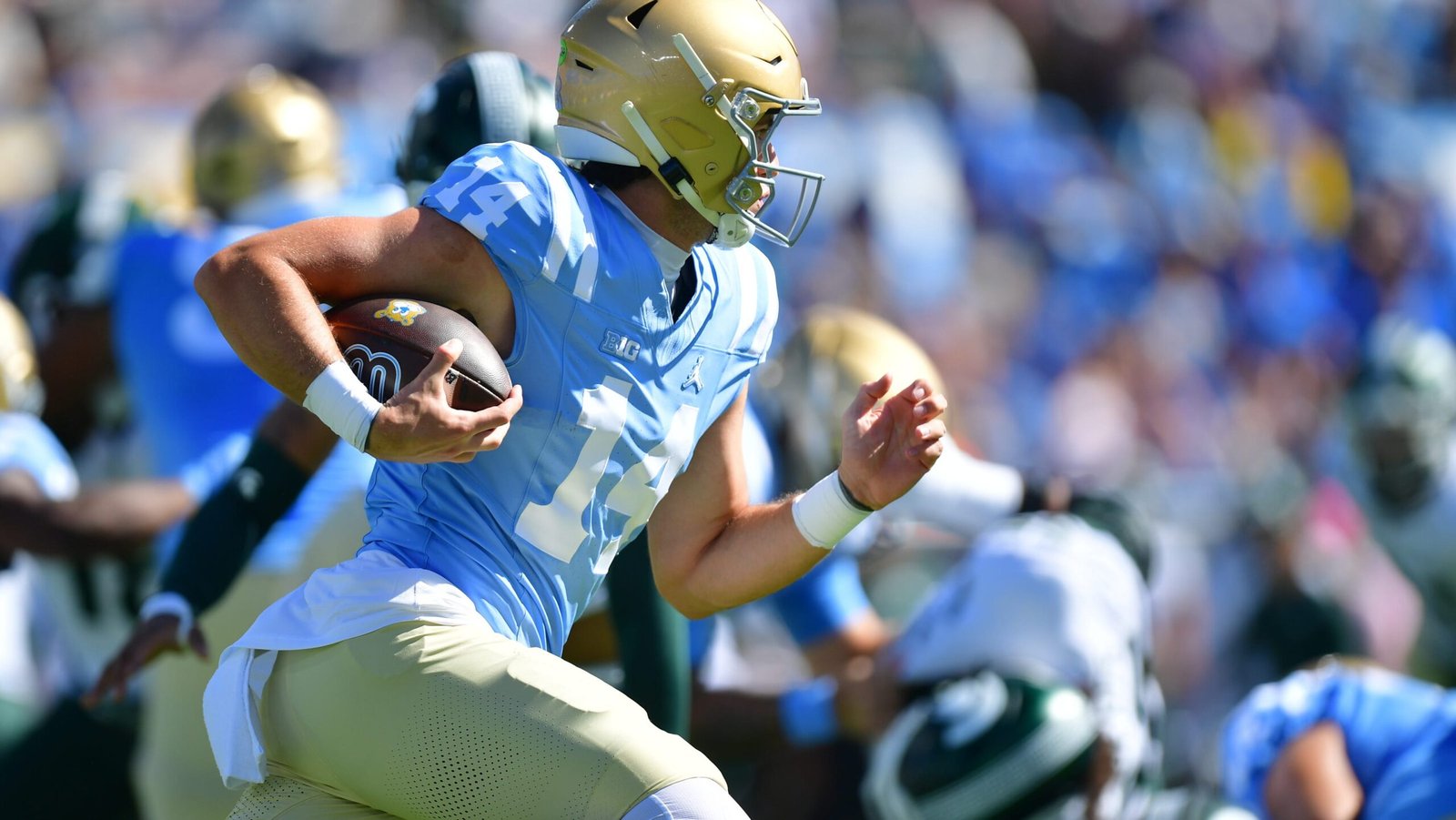 UCLA quarterback Ty Dieffenbach running with the football against Michigan State